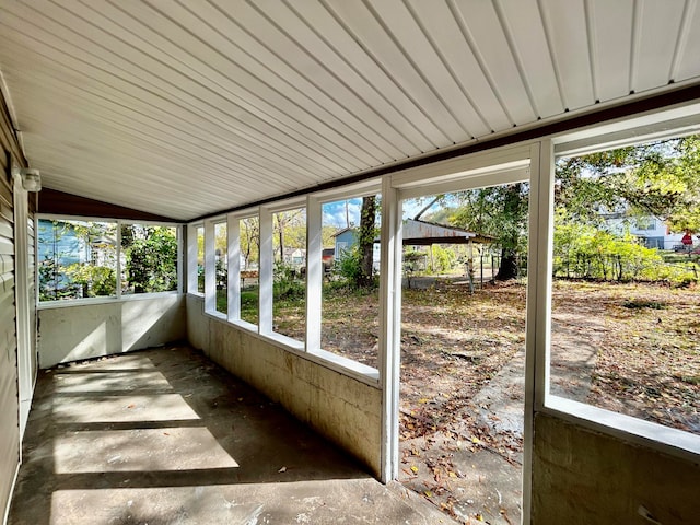 unfurnished sunroom featuring vaulted ceiling