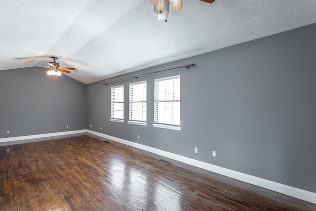 spare room with vaulted ceiling, ceiling fan, dark hardwood / wood-style flooring, and a textured ceiling