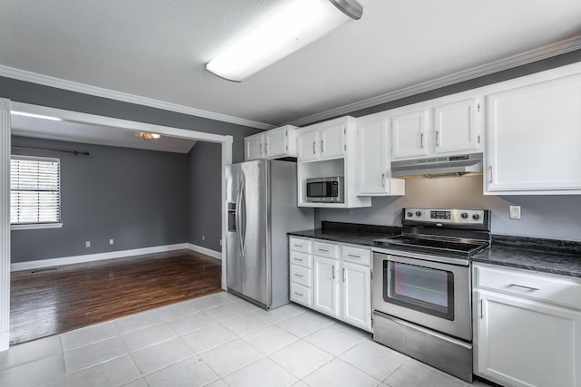 kitchen with white cabinets, appliances with stainless steel finishes, light hardwood / wood-style flooring, and ornamental molding