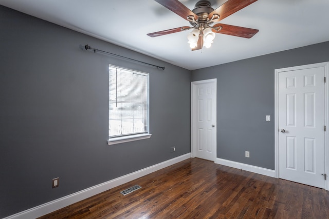 unfurnished bedroom featuring ceiling fan and dark hardwood / wood-style flooring