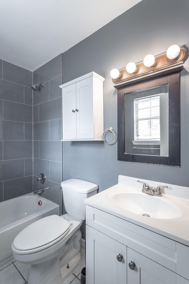 full bathroom with vanity, toilet, tiled shower / bath, and tile patterned flooring