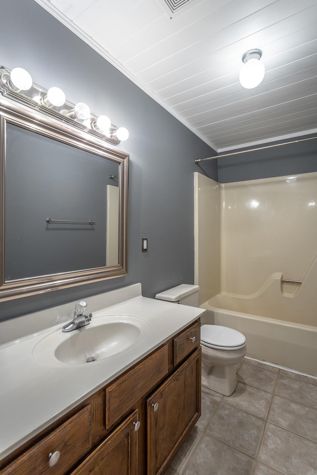 full bathroom featuring tile patterned floors, vanity, bathing tub / shower combination, crown molding, and toilet