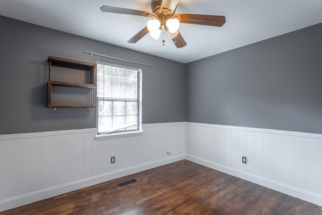 unfurnished room featuring ceiling fan and dark hardwood / wood-style floors