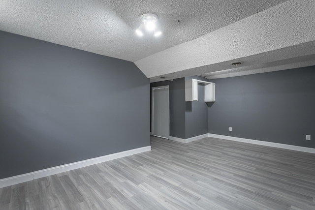 interior space featuring a textured ceiling and hardwood / wood-style flooring