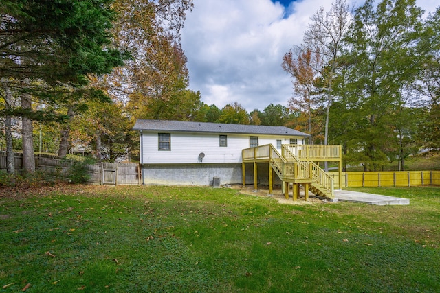 back of property featuring a patio, a lawn, and a wooden deck