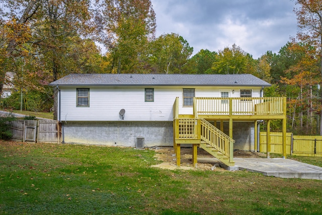 back of property with a yard, a patio, cooling unit, and a wooden deck