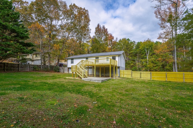 back of house featuring a yard, a deck, and a patio area