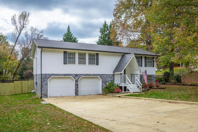 split foyer home with a front lawn and a garage