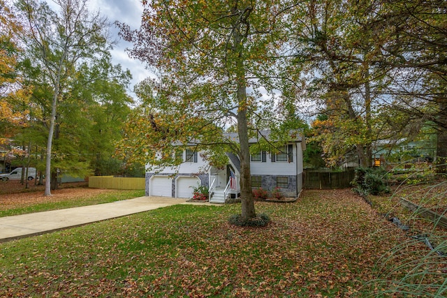 bi-level home featuring a front lawn and a garage