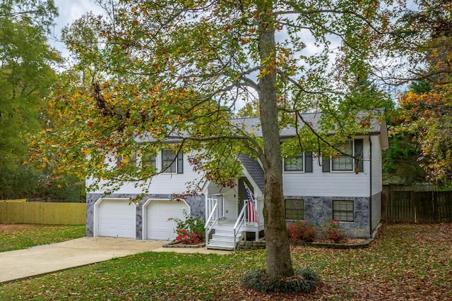 view of front of home with a front lawn and a garage