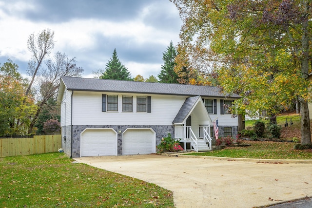 bi-level home with a front yard and a garage