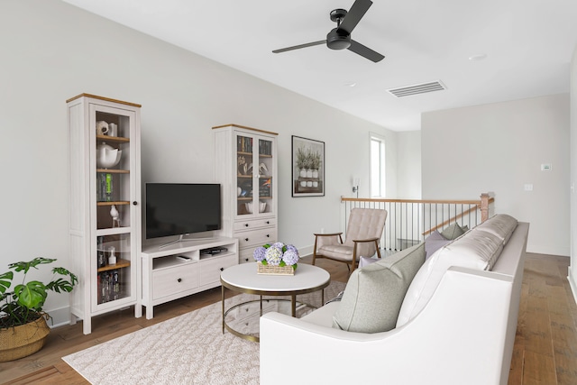 living room with ceiling fan and dark hardwood / wood-style flooring