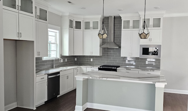 kitchen with hanging light fixtures, wall chimney exhaust hood, light stone counters, dark hardwood / wood-style flooring, and white cabinetry