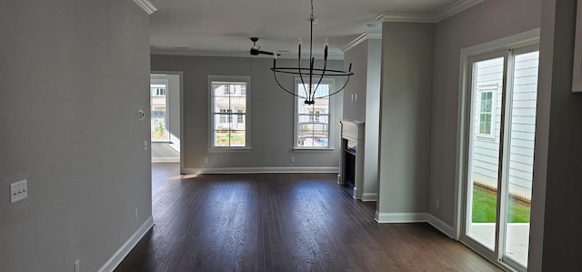 unfurnished dining area featuring ceiling fan, dark wood-type flooring, and ornamental molding