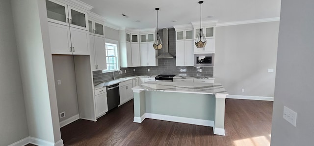 kitchen with appliances with stainless steel finishes, light stone counters, a kitchen island, wall chimney range hood, and white cabinetry