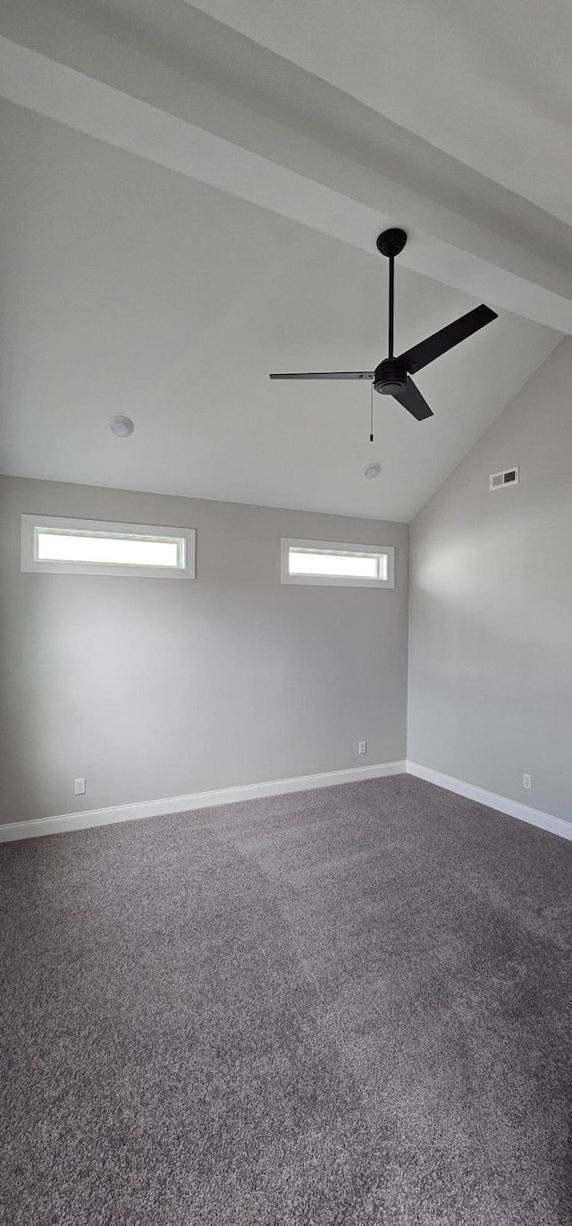 carpeted spare room with vaulted ceiling and ceiling fan