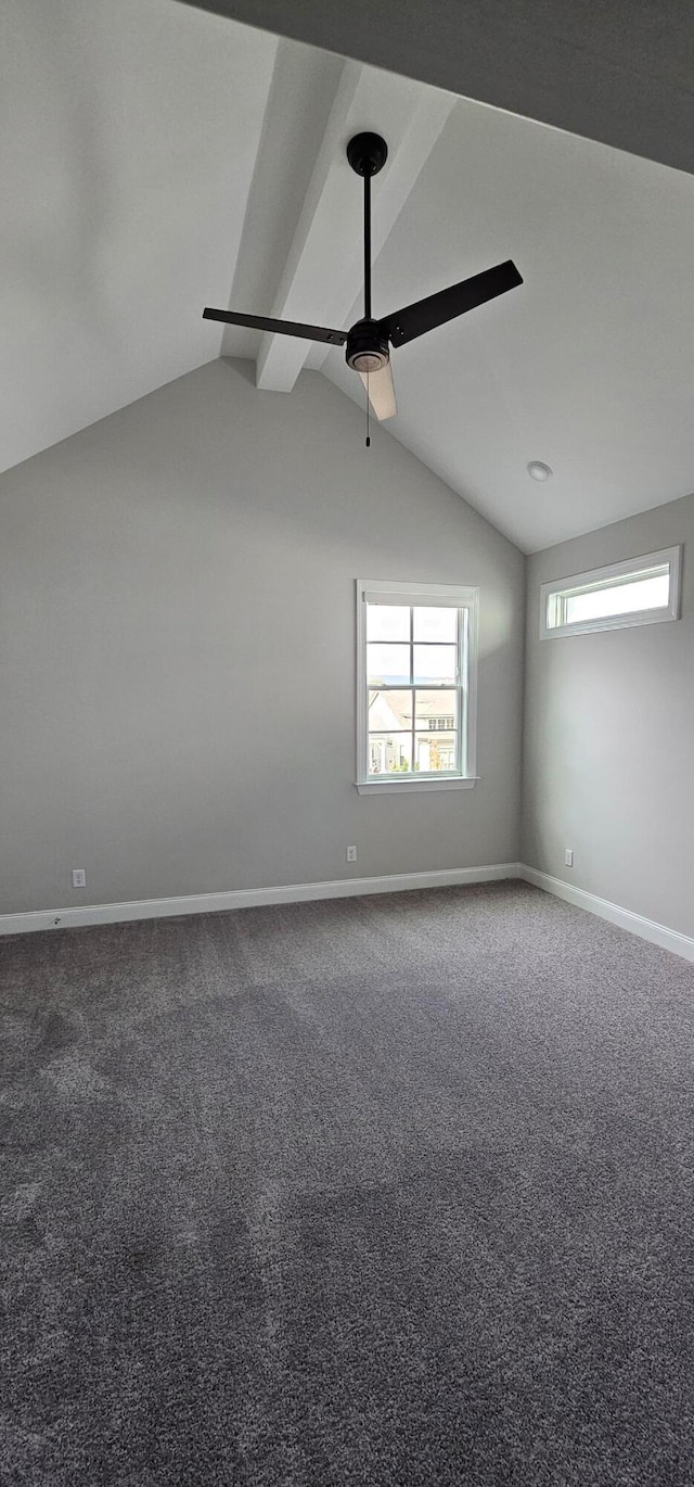 carpeted empty room with vaulted ceiling with beams and ceiling fan