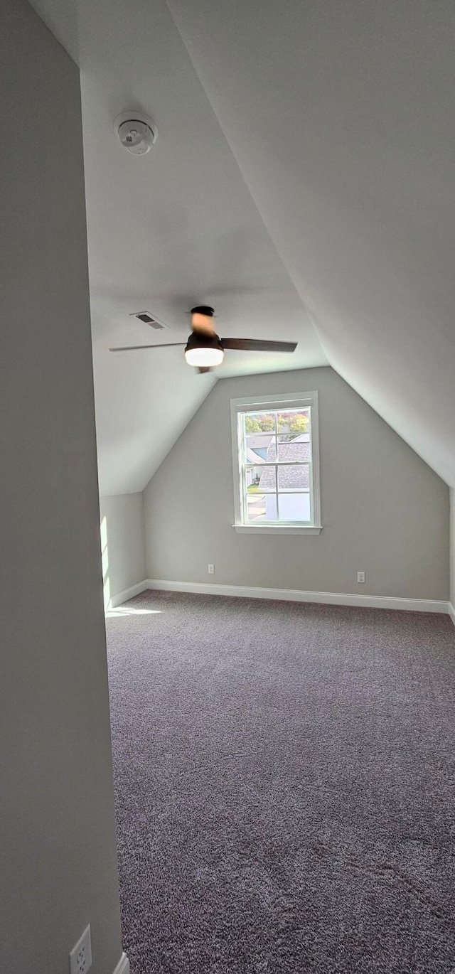 bonus room featuring carpet flooring and lofted ceiling