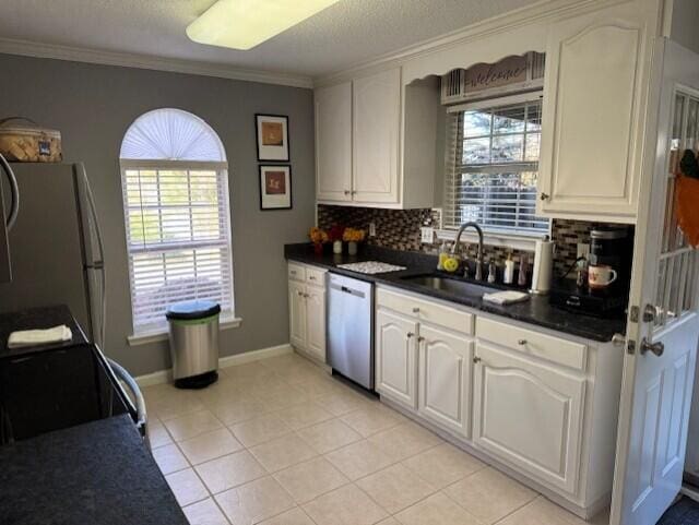 kitchen with decorative backsplash, sink, ornamental molding, and appliances with stainless steel finishes