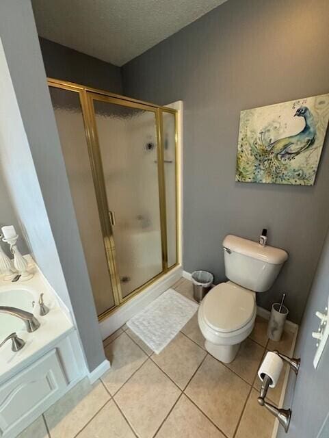 bathroom featuring toilet, a textured ceiling, tile patterned floors, and walk in shower