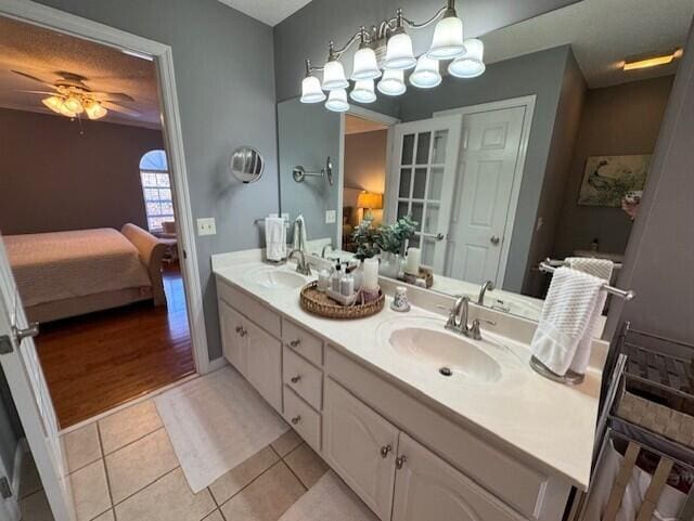 bathroom with tile patterned flooring, vanity, and ceiling fan