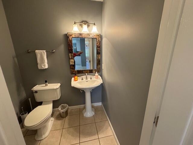 bathroom with toilet and tile patterned floors