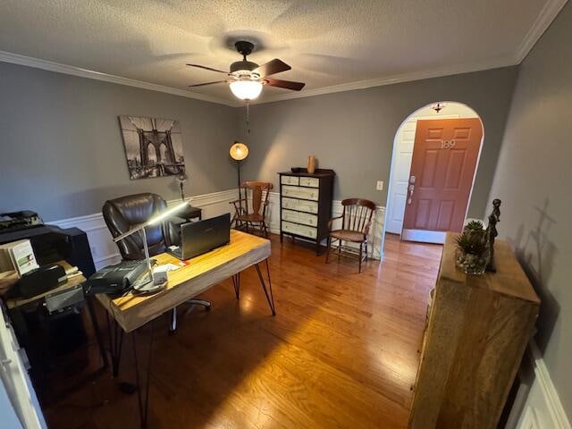 office with crown molding, hardwood / wood-style floors, and ceiling fan