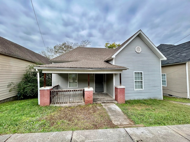 bungalow featuring a front yard and covered porch