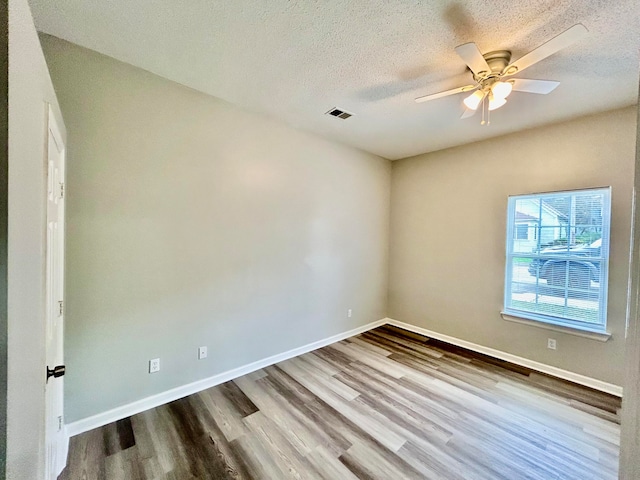 empty room with wood-type flooring, a textured ceiling, and ceiling fan