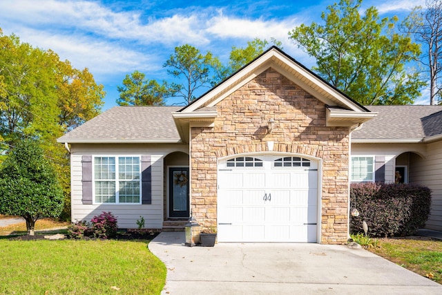 view of front of house featuring a front yard and a garage