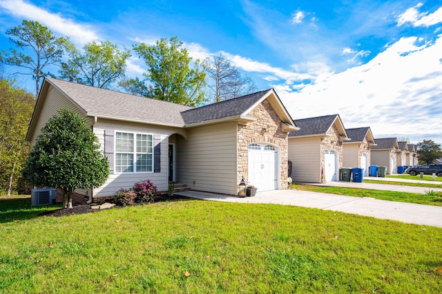 ranch-style house with central AC unit, a front yard, and a garage