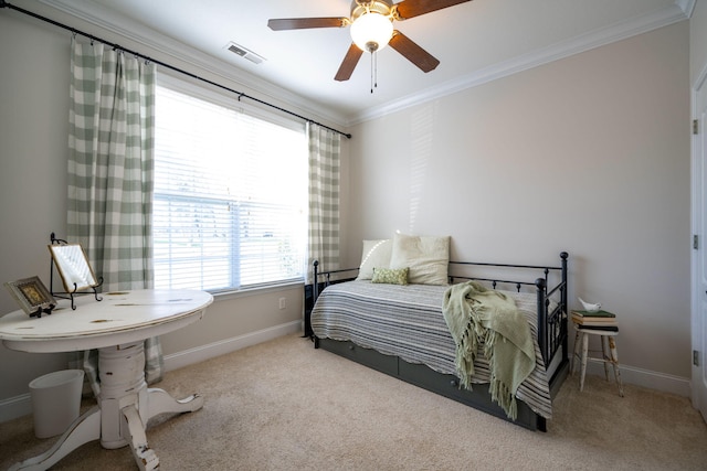 carpeted bedroom with ceiling fan and crown molding