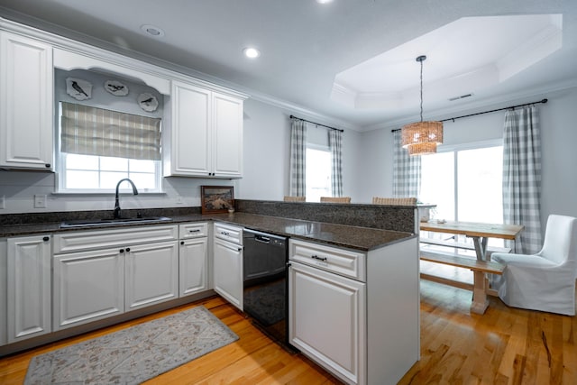 kitchen with white cabinets, kitchen peninsula, and dishwasher