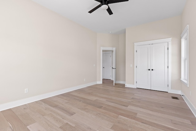 unfurnished bedroom featuring ceiling fan, a closet, and light hardwood / wood-style floors