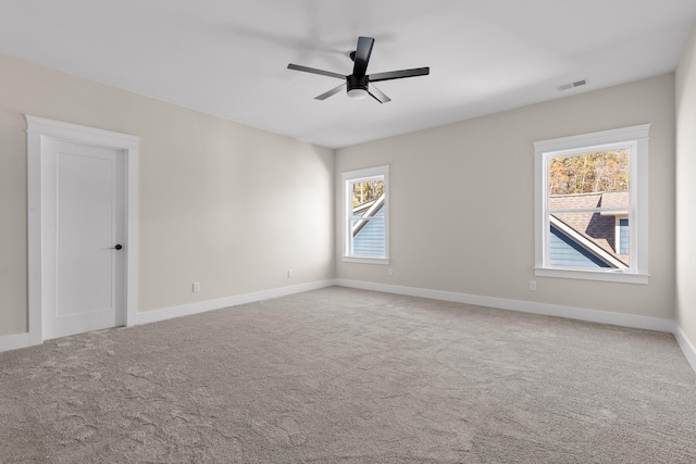 unfurnished room with ceiling fan and carpet floors