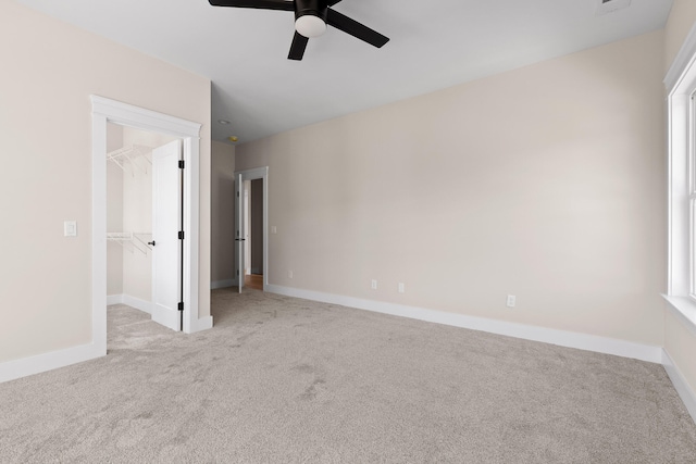 spare room featuring light colored carpet and ceiling fan