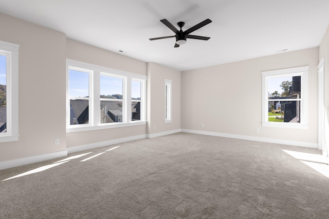 carpeted empty room featuring ceiling fan