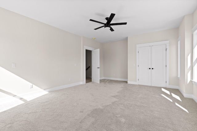 unfurnished bedroom with light carpet and ceiling fan