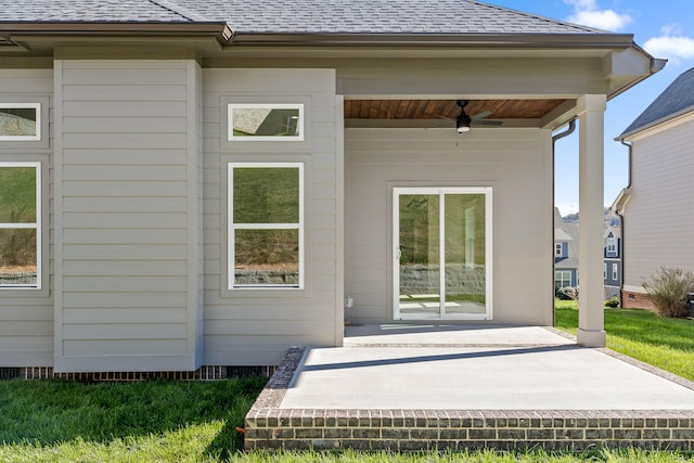 rear view of property featuring ceiling fan