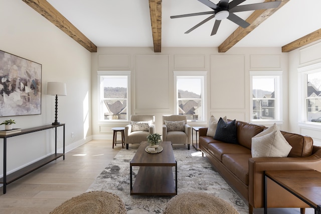 living room with beam ceiling, light hardwood / wood-style flooring, and ceiling fan