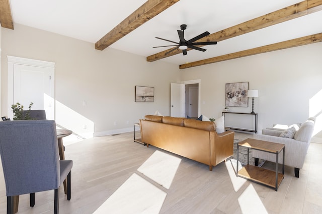 living room with beam ceiling, ceiling fan, and light wood-type flooring