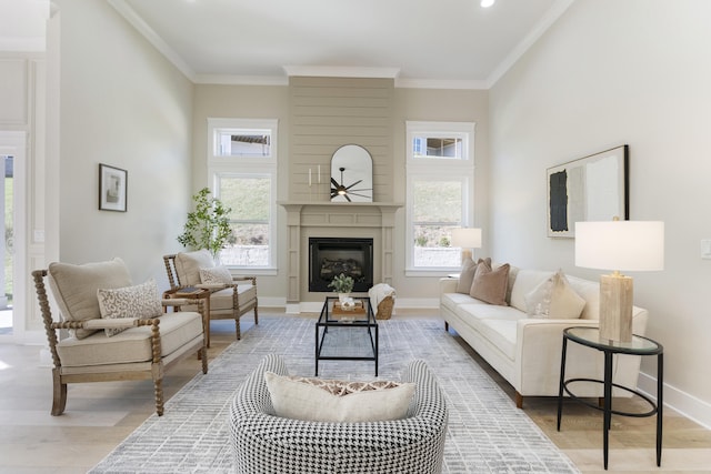 living room featuring a large fireplace, hardwood / wood-style floors, plenty of natural light, and ornamental molding