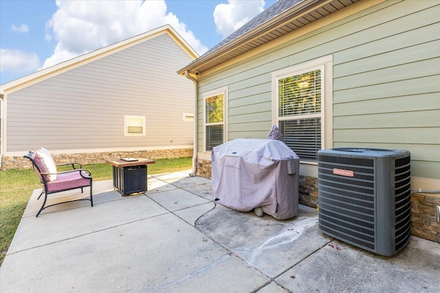 view of patio with area for grilling and central AC unit