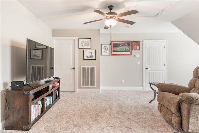 living area with ceiling fan and light colored carpet