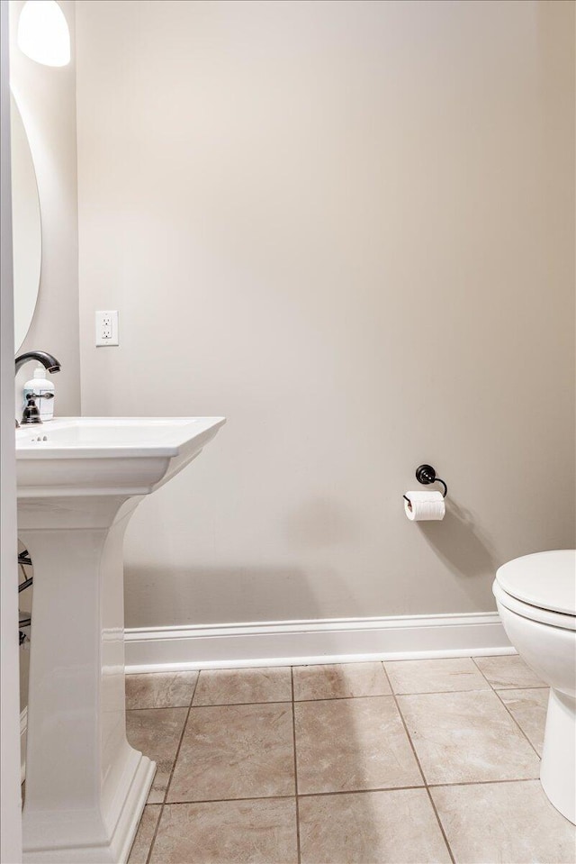 bathroom featuring tile patterned floors and toilet