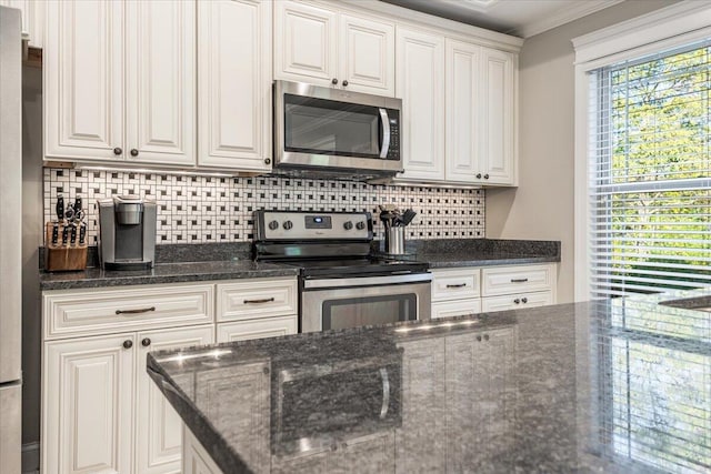 kitchen featuring backsplash, white cabinetry, stainless steel appliances, and ornamental molding