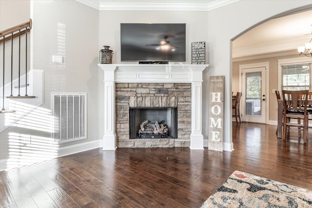 living room featuring dark hardwood / wood-style floors, a fireplace, and crown molding