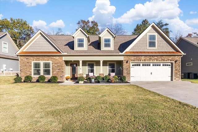 view of front of property with a garage, covered porch, and a front lawn