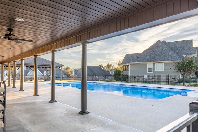 view of swimming pool featuring ceiling fan and a patio area