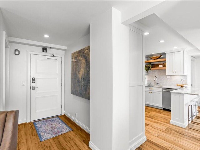 entryway featuring light wood-type flooring and sink